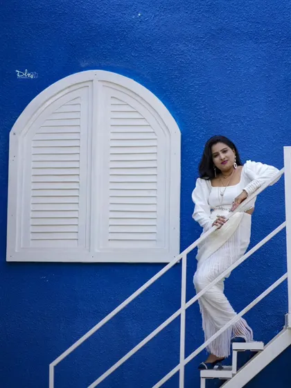 Another stylish shot against the vibrant blue wall and white window of our Santorini set, perfect for solo portraits.