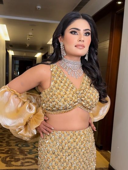 Posing with confidence. The makeup enhances her features and gives her a radiant glow that is perfect for any celebration.