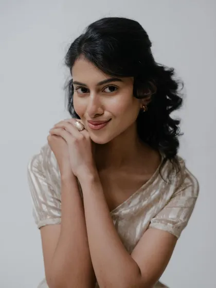 A sweet and gentle pose. The clean makeup enhances her natural smile and features, perfect for a portfolio that requires a range of expressions.