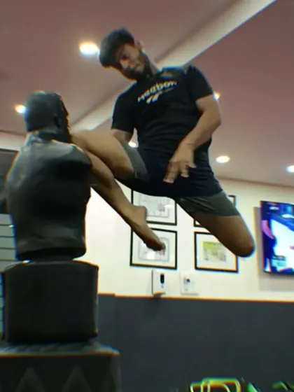 Captured mid-air, a student demonstrates the explosive power and control required for advanced Muay Thai techniques.