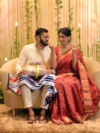A candid moment from a Roka ceremony, where the couple shares a sweet, playful interaction.