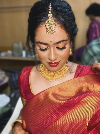 A serene, eyes-closed shot highlighting the blended eyeshadow and bold red lip.