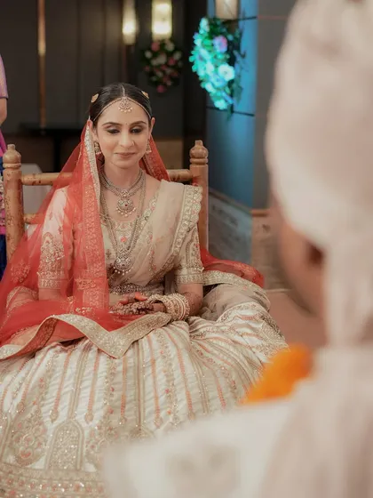 The bride's serene expression as she watches the ceremony, seen from the groom's perspective.