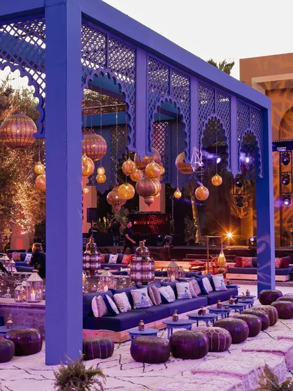 For a destination wedding in Marrakech, we designed an outdoor sangeet lounge that blended Moroccan aesthetics with modern comfort. The custom blue latticework structure and hanging lanterns created a chic and authentic setting under the stars.