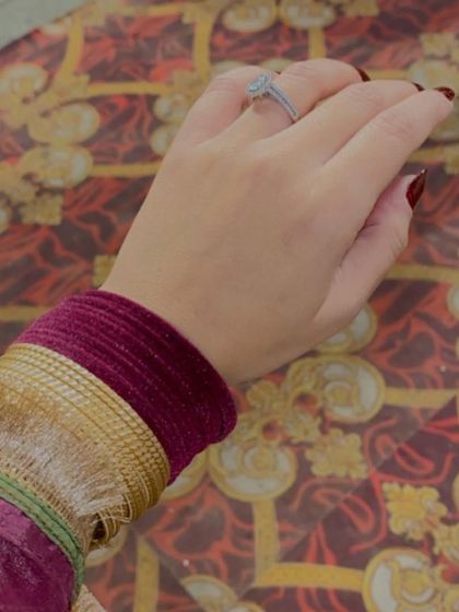 A close-up on the details of a traditional Punjabi look. The combination of wine-colored velvet bangles and simple gold ones adds texture and richness to the sleeve of the suit.