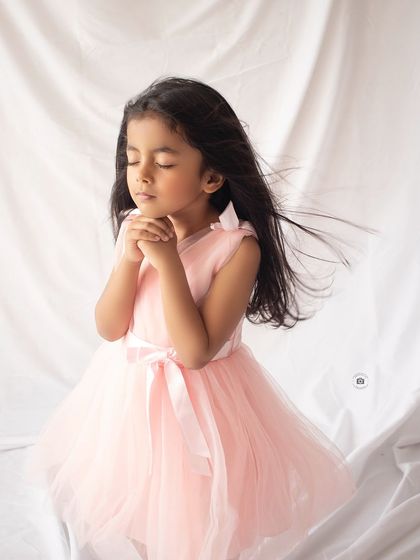A quiet, prayerful pose that feels so peaceful and angelic. The gentle breeze in her hair adds a touch of magic to this fifth birthday portrait.