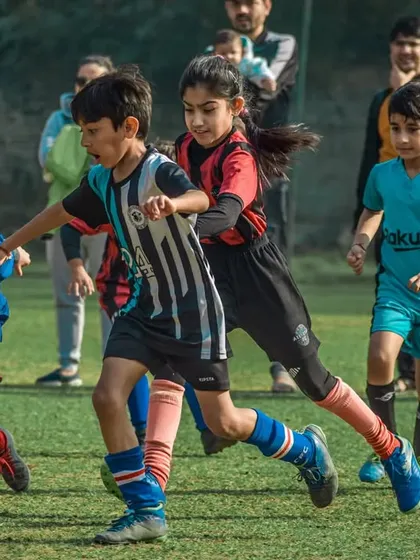 Some of our youngest players, including a girl, compete for the ball in the finals.
