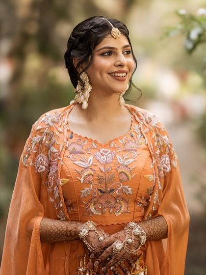 A close-up of the Haldi look, showing the soft makeup and intricate embroidery on her outfit.