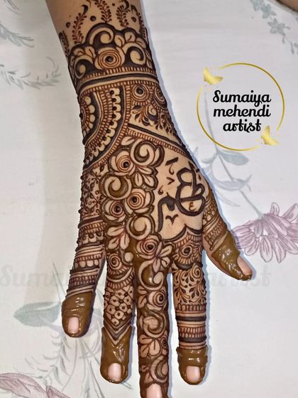 A lovely party henna design with the initials 'S' and 'B' intertwined in a heart. It's a sweet way to add a personal touch to a non bridal design.