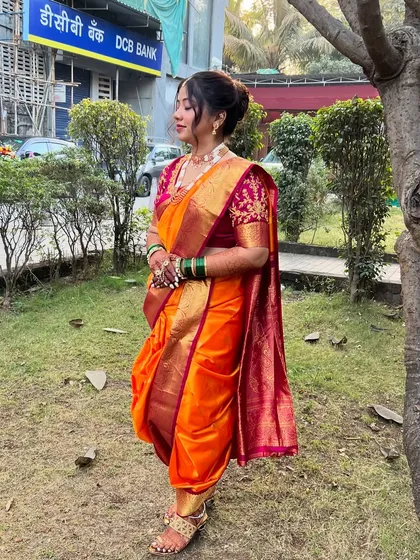 A full-length view of the perfectly draped nauvari saree, showcasing its timeless elegance.