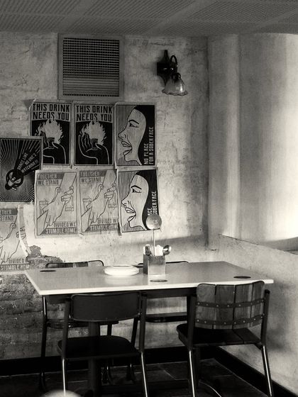 A casual dining corner with a gallery wall of custom graphic art, adding a modern, edgy touch to the otherwise classic interior.