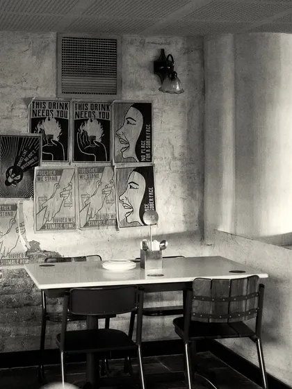 A casual dining corner with a gallery wall of custom graphic art, adding a modern, edgy touch to the otherwise classic interior.