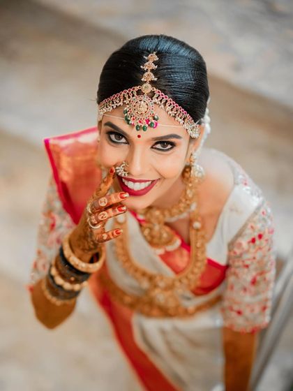 A lovely high-angle shot that highlights the bride's expressive eyes and beautiful smile. The makeup is designed to look stunning from every possible angle.