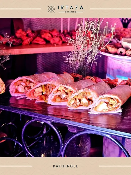 Hearty and flavorful Kathi Rolls, sliced and ready to be served. These are a fantastic, filling option for a more casual event or as part of a larger street food-themed station.
