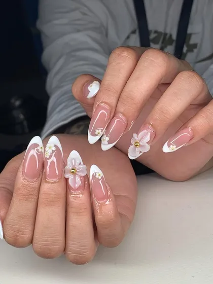 Another view of these stunning 3D floral French tip extensions, showing the detail of the sculpted flowers and gold bead centers.