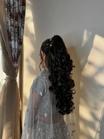 Another angle of the stunning sangeet ponytail, adorned with delicate, starry accessories for that extra touch of glam.