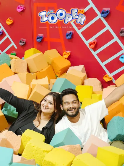 A couple enjoys a happy moment in the foam pit. It proves that you're never too old to dive into fun.