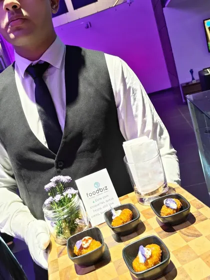 Our professional staff serving curated tapas at a tequila soiree for Mercedes. Impeccable service is a cornerstone of our offering, ensuring guests at high-end corporate functions feel attended to with the utmost care and professionalism.