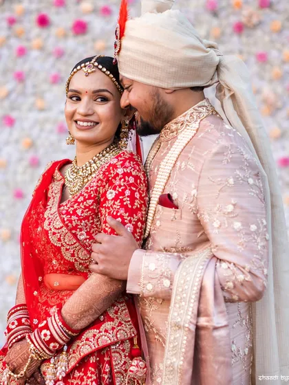 A happy and relaxed couple portrait. The bride's bright smile and the groom's loving embrace make this a very sweet and genuine photo.