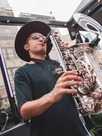Fusing my DJ set with a live saxophonist at a New York City sundowner. I love collaborating with live musicians to add a unique, soulful layer to the party's energy.