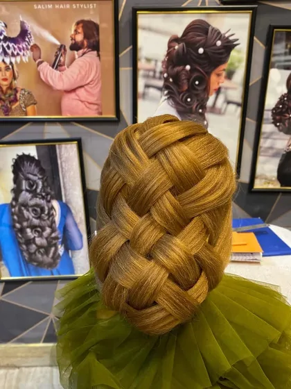 A large, basket weave hairstyle created on a mannequin. This demonstrates a complex weaving technique that results in a highly textured and visually impressive updo.