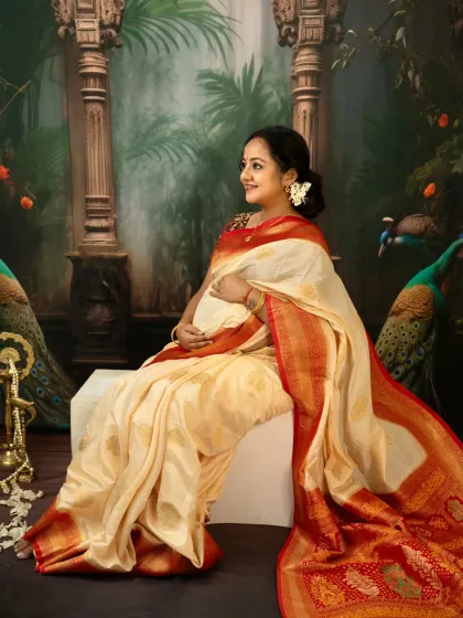 There is a divine grace in motherhood. For this traditional maternity portrait, we used a beautiful silk saree and classic props to create a timeless image. This solo shot focuses on the mother's serene profile and the elegant drape of the fabric over her baby bump.