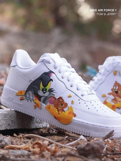 Another shot of the Tom & Jerry custom Air Force 1s, showing both shoes together. The chase continues from one foot to the other.