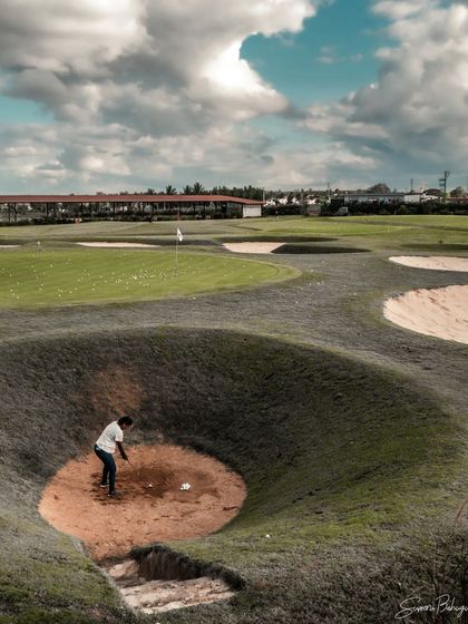 A wide-angle view of our short game area, showing the variety of bunkers and green complexes available for our students to practice on.