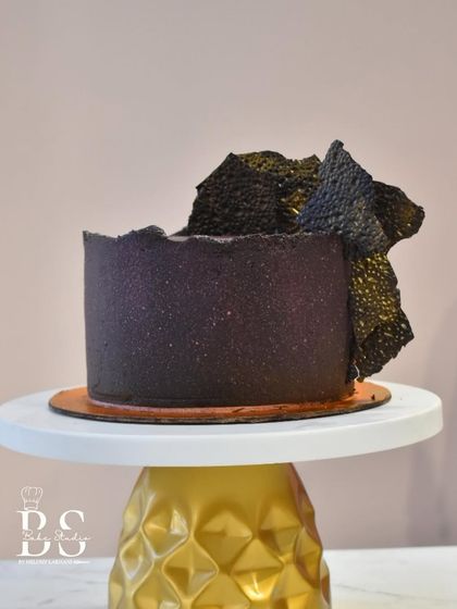 This dark, textured cake showcases the artistic side of working with chocolate ganache, finished with abstract chocolate sails.