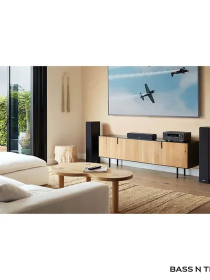 A Denon AV receiver is the heart of a powerful home theatre. This living room setup shows how a high-performance receiver can drive a full surround sound system for an immersive movie experience.