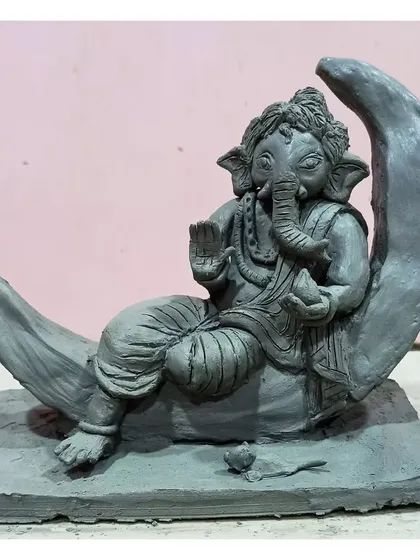 This serene Ganesha rests on a crescent moon, a design I sculpted for the first time based on a client's request. It's a completely handmade Shadu clay idol, perfect for an eco-friendly visarjan.