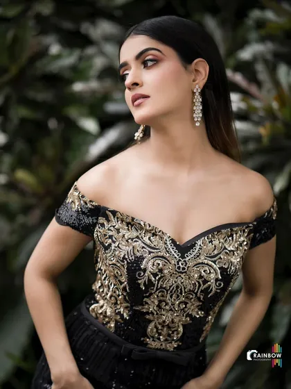 This image demonstrates my work with modern, high-fashion looks. The off-shoulder gown with intricate gold embroidery is the star, and I used natural, diffused lighting against a dark green backdrop to make the details pop and create a moody, elegant portrait.
