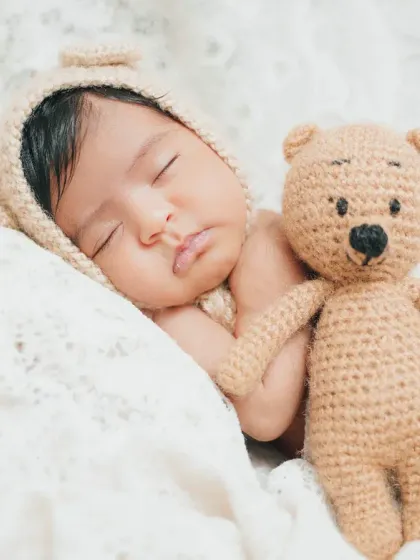 Sometimes, the simplest shots are the most powerful. A peacefully sleeping newborn, cuddled up with a teddy bear, is a timeless image that melts every heart.