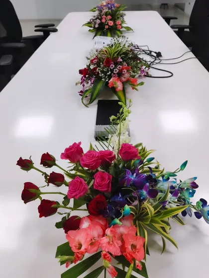 Even in a formal setting like a conference room, details matter. I provide custom floral centerpieces like these, designed to add color and life to the table without obstructing views during meetings.