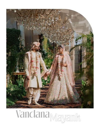 An elegant, framed portrait of the couple walking hand-in-hand at their luxurious garden wedding.