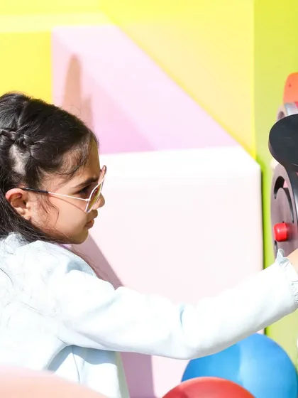 This young explorer is focused on the interactive features of our wall-mounted activity panels.