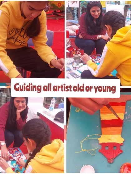 I believe in guiding every artist, young or old. Here I am helping a teenager with her painting at our Christmas carnival stall.