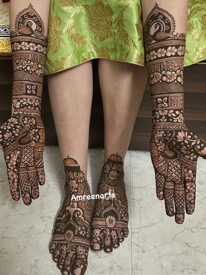 A beautiful composition of full hand and feet mehndi, showcasing traditional peacock and floral motifs in a harmonious design.