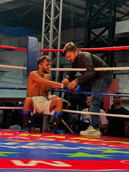 Strategy is key. Here I am in the corner with my fighter, giving him instructions and motivation between rounds.