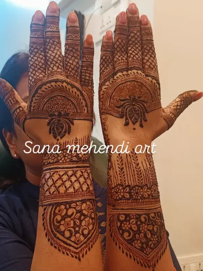 The back of the hands for a full bridal look, featuring a large central mandala and detailed work on the fingers and wrists.