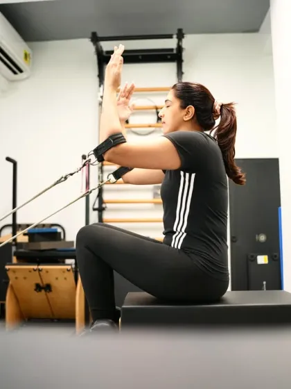 A client finds strength in stillness and power in every breath. This exercise on the reformer connects mind, body, and breath with every controlled move.