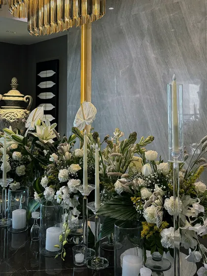 Another angle of the sophisticated Diwali dining decor. The combination of the gold chandelier, white flowers, and soft candlelight creates a truly opulent and festive atmosphere.