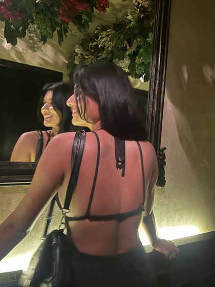 It's the backless era! This shot shows the intricate strappy back of the dress, a key detail that makes the outfit special.