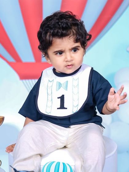 A vibrant and playful Cocomelon themed birthday party, featuring a custom backdrop with all the beloved characters, a colorful balloon arch, and a large light-up number '1' for the birthday boy's special day.