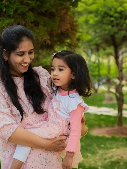 A tender moment between a mother and her daughter in a sunlit park. I focus on capturing the natural interactions and love that define your family's bond.