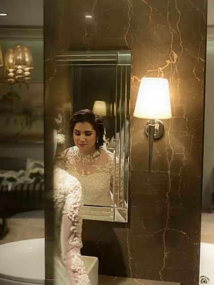 A moment of reflection for the bride before her Christian wedding ceremony. Her elegant updo and soft makeup look beautiful in this artistic shot.