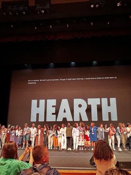 A series of images and graphics from the Hearth Summit, showcasing speakers, panel discussions, and the core mission of the global wellbeing project.