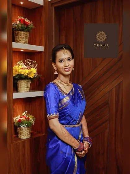 A happy client, Mala, looking stunning in a royal blue silk saree paired with a custom embroidered blouse I designed for her.