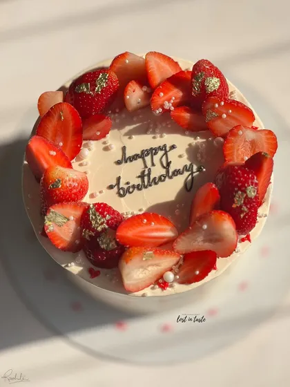 A seasonal favorite, this Vanilla Strawberry cake is topped with fresh strawberries, edible gold leaf, and tiny sugar pearls. It's available as a celebration cake or a smaller bento cake.
