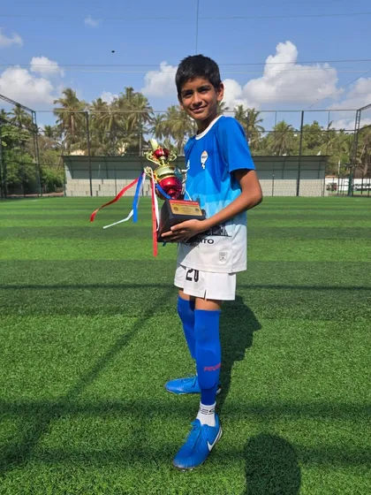 A young champion from our U12 team with his trophy.